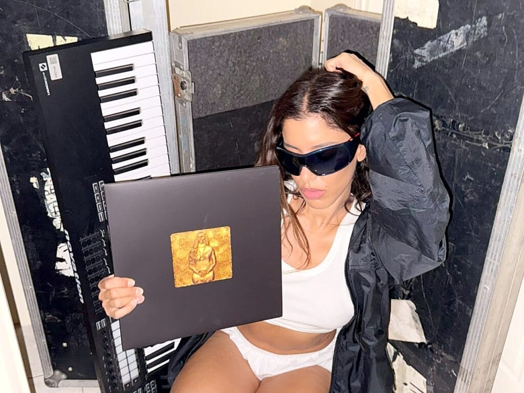 Marina Satti posing with the gold-stamped YENNA sleeve
