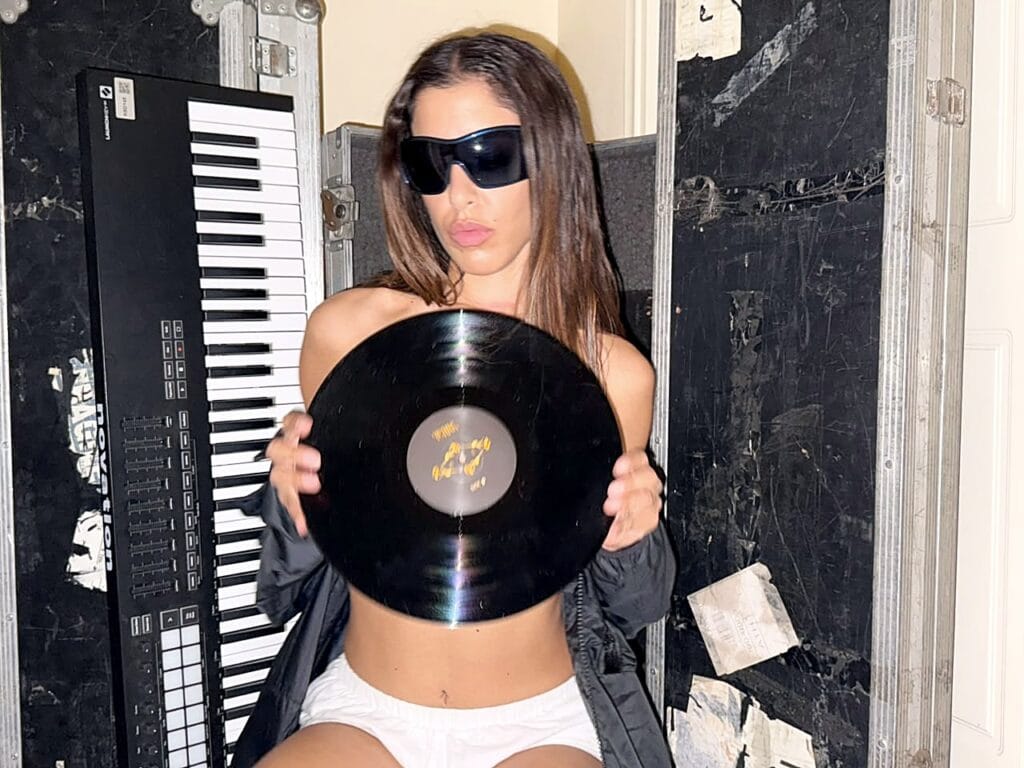 Marina Satti holding the black YENNA vinyl record